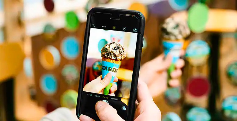taking picture of ice cream cone with cell phone